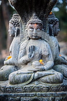 Close up buddhist statue Kathmandu Nepal. Close up of oblations of food and flowers to their gods on small statues , Kathmandu