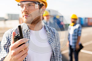 Close up of builder in hardhat with walkie talkie