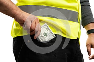Close-up of builder wearing vest putting cash money in pocket