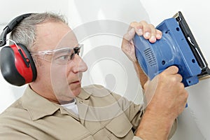 Close up builder working with grinding tool