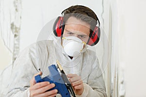 Close up builder working with grinding tool