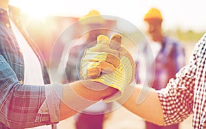 Close up of builders hands making handshake photo