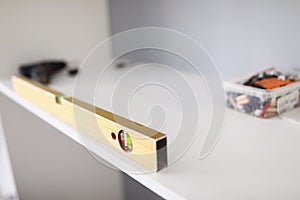 Close up of building level and self-tapping screws