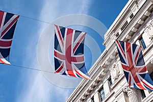 Close up of building on Regent Street London with row of British flags to celebrate the wedding of Prince Harry to Meghan Markle