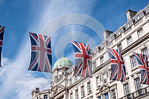 Close up of building on Regent Street London with row of British flags to celebrate the wedding of Prince Harry to Meghan Markle