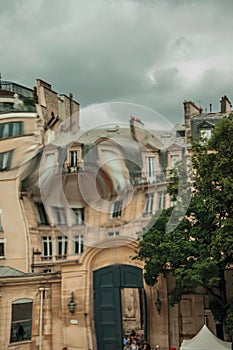 Close-up of buildings with natural distortions without post-production techniques caused by real deformations in window glass at