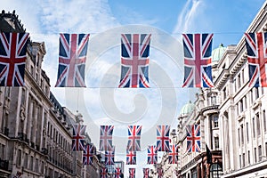 Close up of buildings on Regent Street London with row of British flags to celebrate the wedding of Prince Harry to Meghan Markle