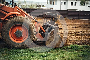 Close up of bulldozer scoop moving earth and doing landscaping works