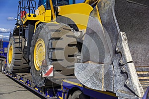 Close-up bulldozer on a transport platform. Concept: road construction, heavy construction equipment