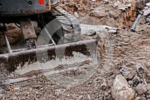 Close up of bulldozer working with soil on construction site