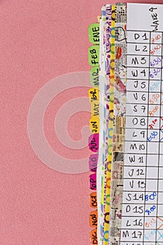 Close-up of Bullet Journal-style notebook labels with daily task follow-ups in colored grids. Habbit Tracker in Spanish photo