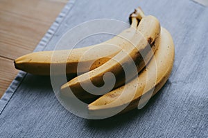 Close-up of a bunch of bananas on a dark fabric