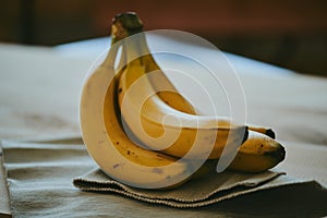 Close-up of a bunch of bananas on a dark fabric