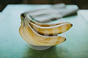 Close-up bunch of bananas on green background
