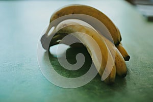 Close-up bunch of bananas on green background
