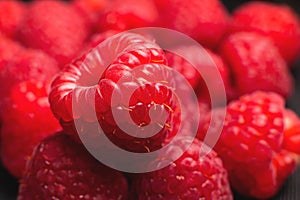 Close up, a bunch of fresh and ripe red raspberries. Pink raspberry macro shot