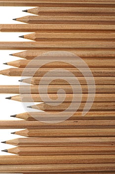 Bunch of identical graphite pencils on white background