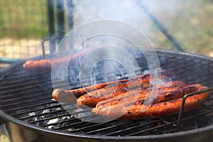 Close-up of a bunch of merguez sausages roasting on a barbecue