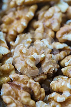 Close-up of a bunch of walnuts, with out of focus background. Vertical view