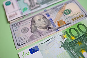 close up bundle of money Euros, dollars, rubles banknotes on the blue background, business, finance, saving, banking concept