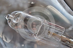 Close-up of a burned out malfunctioning incandescent light bulb with broken wolfram filament inside a glass lamp.