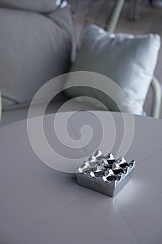 Close up burning cigarette in ashtray on table