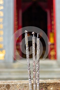 Close-up of burning incense sticks at an Asian temple