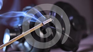 Close-up of burning incense sticks with smoke, relaxing music.