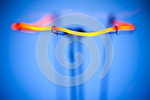 Close-up of burning light bulb with tungsten filament in center