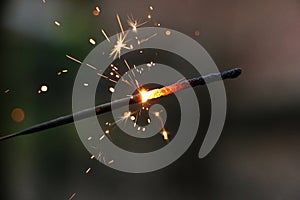 A close up of a burning sparkler in the silvesters night