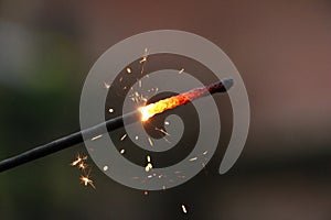 A close up of a burning sparkler in the silvesters night photo