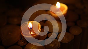 Close-up of burning tealight candle on table in home