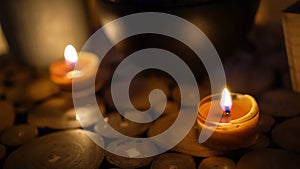 Close-up of burning tealight candle on table in home