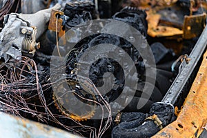 A close-up of the burnt-out engine compartment of a car