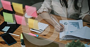 Close up business or accountant woman working in finance and accounting Analyze financial budget in the office. Business