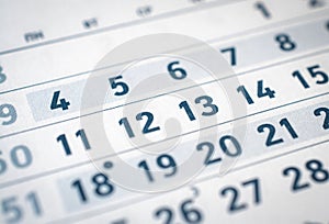Close up of business calendar eleven, twelve, thirteen translate: month of December