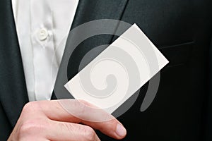 Close-up of business card in business mans hand