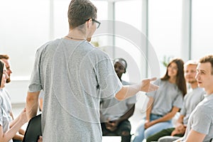 Close up. business coach holds a debate with a group of young people