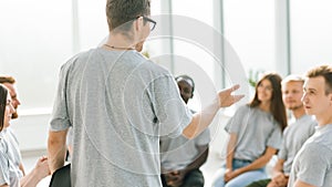 close up. business coach holds a debate with a group of young people