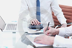 Close up.business colleagues compiling financial report