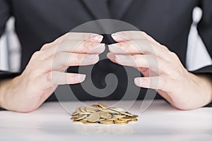 Close up business hands save money to stack of coins.