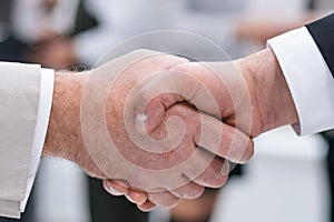 Close up. business handshake on office background.