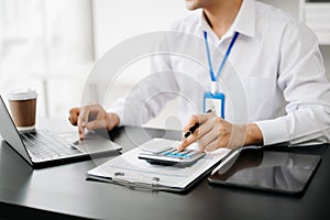 Close up of business man or accountant hand typing laptop working to calculate on desk about cost at office