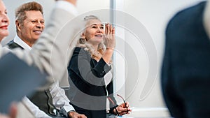 Close up. business man asks a question during a business seminar.