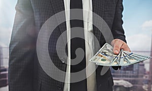 close up business man in classik black siut hold and check dollar