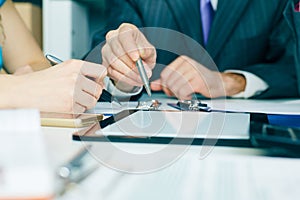 Close-up the business man hand pointing at the tblank tablet screen. Teamwork successful meeting.