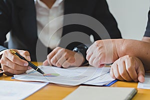 Close up of business man hand working with financial business graph information, analyzing investment charts