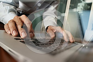 Close up of business man hand working on laptop computer