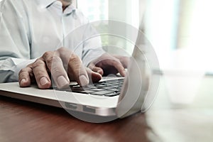 Close up of business man hand working on laptop computer