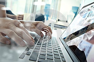 Close up of business man hand working on laptop computer